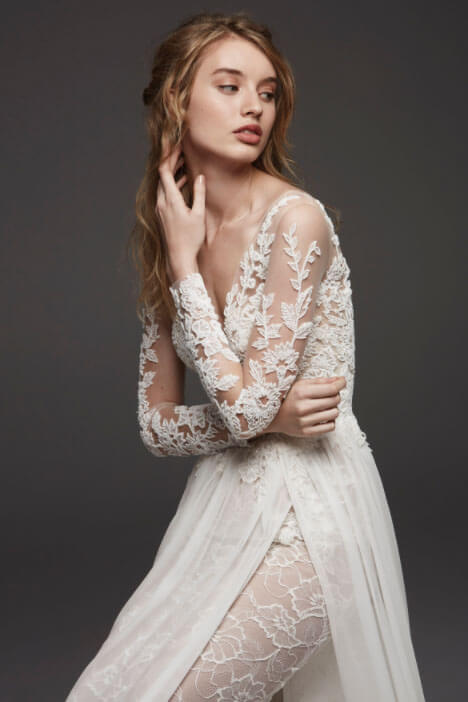 Model wearing a white gown by Lillian West. Mobile image