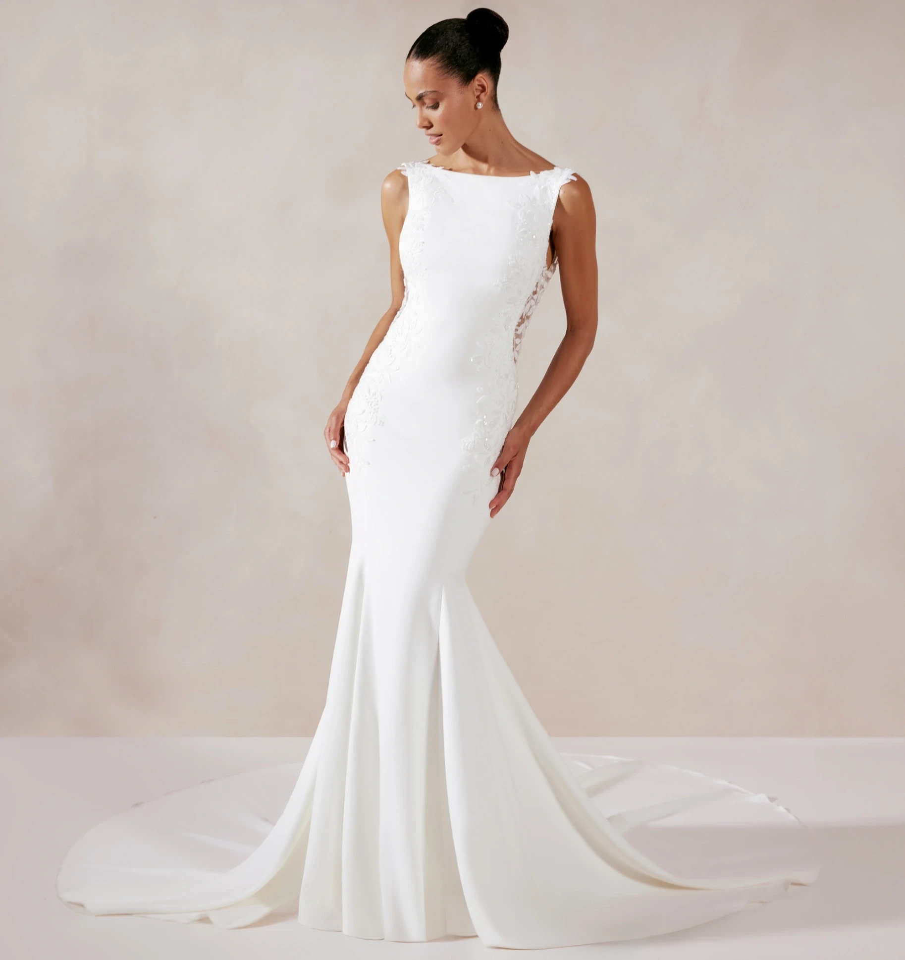 Model wearing a white gown by Adore by Justin Alexander Fall 2024